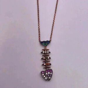 Rainbow CZ gems embellish this contemporary fishbone pendant necklace